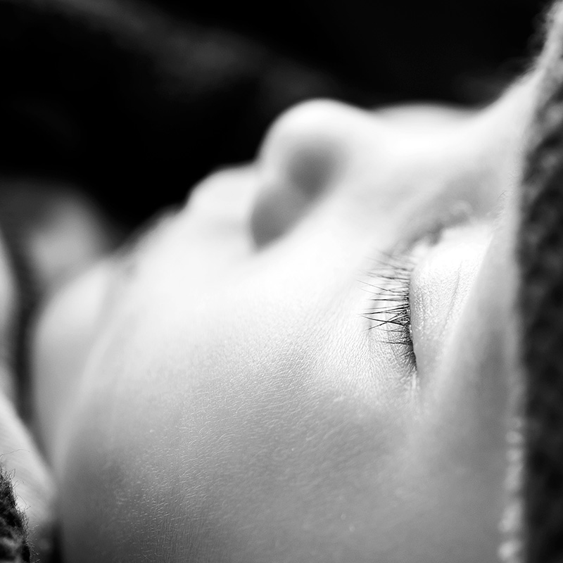 Focus on the closed eyes of a sleeping baby